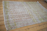 Distressed Oushak rug featuring pale cochineal, lime green, dusty blush trellis pattern.