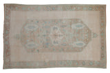 Distressed vintage Oushak rug, central lozenge medallion in cream, coffee, mint, and mauve tones, 6'x9'4