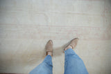 Distressed Dosemealti carpet with soft platinum silver and blush rose geometric patterns underfoot.