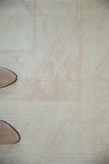 Distressed vintage Dosemealti carpet, showing uniform wear and faint blush rose pattern.