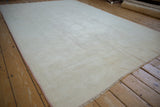 Distressed Dosemealti carpet with even wear, platinum silver pile, and dusty blush rose selvage.