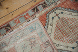 Folded vintage distressed Oushak rug, with worn pile texture and hand-knotted foundation visible.