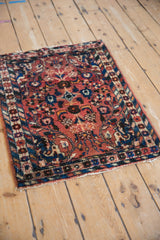 Borchalou rug corner showcasing barber pole border, floral design, and tattered fringe.