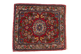Vintage Qazvin square rug with a scalloped medallion on a cherry red field of scrolling florals.