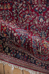 Detailed view of a vintage Sarouk rug's even pile and intricate floral spray design.