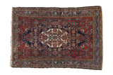 Vintage Persian Bibikabad rug featuring inverted Herati medallion on cherry red and dark navy field.