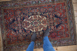 Vintage Persian Bibikabad rug, ivory medallion, Herati motif, cherry red, navy, even wear.