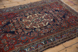 Vintage Bibikabad rug edge showing scrolled leaves, floral cross sections, and even wear.