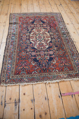 Vintage Bibikabad rug's cream fringe and intricate red, blue, ivory floral border.