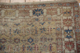 Antique Caucasian rug detail: Worn floral pattern in saffron, sky blue, terracotta, foundation showing.