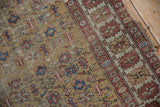 Antique Caucasian rug field shows intricate checkered blossoms, saffron tones, and wear.