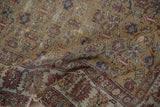 Worn pile and distinctive geometric border of antique Caucasian rug, in saffron, blue, terracotta.