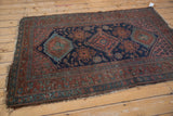 Kurdish Hamadan rug's madder root red, navy floral border with visible end tatter.