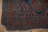 Kurdish Hamadan rug corner, tattered fringe, blush and navy blue floral motifs, knot wear.