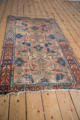 Dusty rose field of antique Lilihan rug, blue palmettes, geometric border, hard wear, tattered edge.