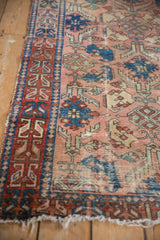 Antique Lilihan rug detail showing worn dusty rose field, sapphire palmettes, and serpent border.