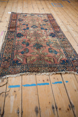 Detail of tattered fringe and worn geometric border on an antique Lilihan rug.