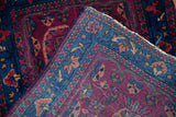 Hand-knotted sapphire blue foundation weave and rich burgundy floral pile of the Farahan Sarouk rug.