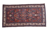 Vintage Persian Malayer rug with a complex geometric medallion and vine pattern on a navy blue field.