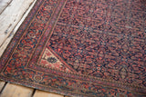 Vintage Farahan Sarouk rug corner, detailed Herati field, meandering vine boteh border, navy, terra cotta.