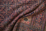Corner detail of vintage Farahan Sarouk rug, sand-toned spandrel, Herati field, and navy, terra cotta borders.