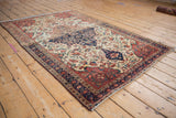 Antique Farahan Sarouk rug: ivory field with delicate floral vinery, navy and red borders.