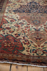 Antique Farahan Sarouk rug exhibiting detailed floral vinery in varied red, green, and ivory.