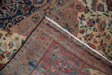 Antique Farahan Sarouk corner, hand-knotted floral border, vinery, and abrash on ivory field.