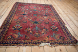 Worn fringe and triple meandering vine border of a vintage Lilihan rug.