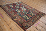 Antique Persian Hamadan rug corner with madder red turtle motif border.