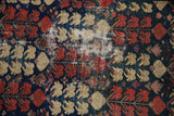 Antique Hamadan rug's navy, red, beige germinating plant pattern, with visible worn foundation.
