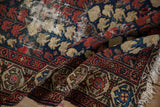 Antique Hamadan rug border detail showcasing madder red turtle motifs and worn fringe.