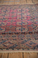 Dusty magenta abrashed field, navy blue guls, and intricate multi-layered border of antique Turkmen rug.