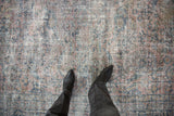 Distressed Mahal rug texture revealing faded pink, teal patterns and exposed foundation.