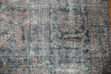 Detail of distressed Mahal rug with exposed foundation and muted floral pattern.