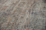 Distressed Mahal carpet with dusty cochineal pink, teal, gold floral motifs and visible foundation.