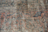 Distressed Mahal carpet with dusty pink, teal floral motifs and visible foundation.