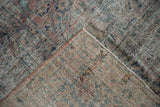Distressed vintage Mahal carpet corner revealing foundation wear and side cord selvage.