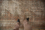 Vintage Distressed Hamadan carpet, faded herati design, dusty hues, and prominent exposed foundation.
