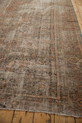 Distressed vintage Hamadan carpet with faded herati pattern and visible foundation.