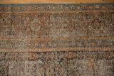 Distressed texture revealing foundation and faded herati pattern on a vintage Hamadan rug.