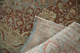 Distressed hand knotted Kashan carpet revealing fine foundation weave and worn red, blue patterns.