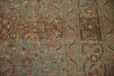 Distressed Kashan carpet detail: dusty blue field, wine red florals, with visible knot wear.