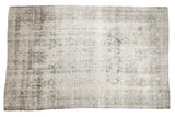 Distressed antique Kerman carpet with a faint tree of life design in ivory, silver, and charcoal.