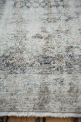 Close-up of the distressed Kerman's weave, revealing the ivory foundation beneath low pile.