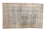 Vintage distressed Persian Meshed carpet with faded palmettes in dark denim blue, ivory, and sand.