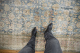 A close look at the heavily distressed texture and exposed foundation of a vintage Meshed carpet.