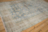 Visible foundation and time-softened pile on a vintage distressed Persian carpet.