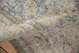 A soft fold in the vintage carpet highlights its textured weave and visible foundation.