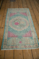 An angled view of the distressed vintage Oushak rug runner, showing its soft wear and texture.